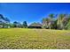 Large, well-maintained yard surrounding a charming home, offering plenty of space and privacy at 122 Wgto Tower Rd, Lake Alfred, FL 33850