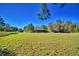 Sprawling lawn with a glimpse of the home, offering ample space for recreation and relaxation at 122 Wgto Tower Rd, Lake Alfred, FL 33850