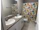 Bright bathroom featuring double sinks, granite countertop, and a shower-tub combo at 1393 Axel Cir, Winter Haven, FL 33880