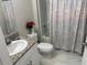 Bright bathroom featuring a granite vanity top, a sleek sink, and a bathtub with shower at 1393 Axel Cir, Winter Haven, FL 33880