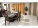 Well-lit dining room featuring an elegant dining table, stylish chairs, and decorative window coverings at 1393 Axel Cir, Winter Haven, FL 33880