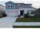 Charming two-story home with a well-maintained front yard and attached two-car garage at 1393 Axel Cir, Winter Haven, FL 33880