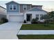 Charming two-story home with a well-maintained front yard and attached two-car garage at 1393 Axel Cir, Winter Haven, FL 33880