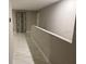 Bright hallway with tile flooring, neutral paint, and modern lighting fixtures at 1393 Axel Cir, Winter Haven, FL 33880