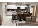 Open kitchen with white cabinets, granite countertops, stainless appliances and a breakfast bar at 1393 Axel Cir, Winter Haven, FL 33880