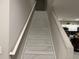 Clean stairway features bright tiling and a white handrail connecting floors in the home at 1393 Axel Cir, Winter Haven, FL 33880