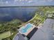 Community amenities by a lake with gardens, pool, clubhouse and recreation area at 1402 Colonial Ct, Winter Haven, FL 33884