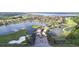 Beautiful aerial view of community entrance, with golf course, lakes, and homes at 1402 Colonial Ct, Winter Haven, FL 33884