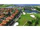 An aerial view of homes, golf course, and a large clubhouse, showcasing luxury living within a serene community at 1402 Colonial Ct, Winter Haven, FL 33884