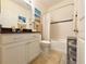 Bright bathroom featuring a shower-tub combination, white cabinets, and neutral decor at 1402 Colonial Ct, Winter Haven, FL 33884