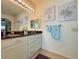 Large vanity and double sinks of a bright bathroom, enhanced by stylish decor and ample lighting at 1402 Colonial Ct, Winter Haven, FL 33884