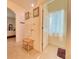Neutral bathroom featuring a tiled floor and an adjacent powder room for added convenience at 1402 Colonial Ct, Winter Haven, FL 33884