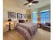 Inviting bedroom featuring a ceiling fan, comfortable bed, and natural light from the windows at 1402 Colonial Ct, Winter Haven, FL 33884