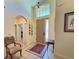 Elegant home foyer featuring high ceilings, decorative rugs, and a view into other living spaces at 1402 Colonial Ct, Winter Haven, FL 33884