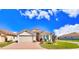 Charming single-story home with a well-manicured lawn, brick driveway and two car garage at 1402 Colonial Ct, Winter Haven, FL 33884