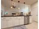 White kitchen featuring a granite island, stainless appliances, and an open concept design at 1402 Colonial Ct, Winter Haven, FL 33884