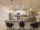 Bright kitchen with granite countertops, stainless steel appliances, and a breakfast bar with seating at 1402 Colonial Ct, Winter Haven, FL 33884