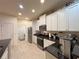 Well-lit kitchen showcasing stainless steel appliances, granite countertops, and ample cabinet space at 1402 Colonial Ct, Winter Haven, FL 33884