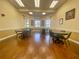 Bright lounge area with tables, chairs, stylish window coverings, and attractive wall decor at 1402 Colonial Ct, Winter Haven, FL 33884