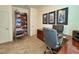 Functional office with a chair, built-in shelving, and a large workspace at 1402 Colonial Ct, Winter Haven, FL 33884