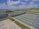 Outdoor shuffleboard courts with lighting and covered seating near a scenic pond at 1402 Colonial Ct, Winter Haven, FL 33884