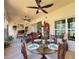Inviting sunroom with a glass dining table, comfortable seating, and bright natural light at 1402 Colonial Ct, Winter Haven, FL 33884