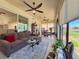 Charming sunroom with comfortable seating and an adjacent dining area at 1402 Colonial Ct, Winter Haven, FL 33884