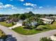 Spacious home on a corner lot with a large yard and mature trees, surrounded by well-kept properties at 1409 Berkley Ct, Winter Haven, FL 33880