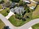 Aerial view of home with lush landscaping, screened pool, and well-maintained lawn at 1409 Berkley Ct, Winter Haven, FL 33880