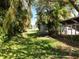 View of the backyard with tropical foliage and fence at 1409 Berkley Ct, Winter Haven, FL 33880