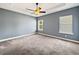Bedroom with plush gray carpet, neutral walls, and a ceiling fan at 1409 Berkley Ct, Winter Haven, FL 33880