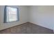 A simple bedroom with carpeted floors and a window with blinds at 1409 Berkley Ct, Winter Haven, FL 33880
