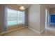 Cozy dining area featuring tile flooring, a large window overlooking the pool, and elegant light fixture at 1409 Berkley Ct, Winter Haven, FL 33880