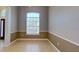 Dining room with tile flooring, chair rail and arched window at 1409 Berkley Ct, Winter Haven, FL 33880