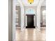 Elegant entryway featuring tile flooring, high ceilings, and an arched window above the dark wood front door at 1409 Berkley Ct, Winter Haven, FL 33880