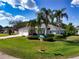 Charming one-story home featuring well-maintained landscaping, a three-car garage, and inviting curb appeal at 1409 Berkley Ct, Winter Haven, FL 33880