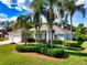 Spacious single-story home with lush landscaping, a well-manicured lawn, and a side-entry three-car garage at 1409 Berkley Ct, Winter Haven, FL 33880