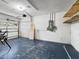 Functional garage space with a blue painted floor, a garage door, and an electrical panel at 1409 Berkley Ct, Winter Haven, FL 33880