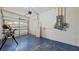 An organized garage with blue floor and electrical panel at 1409 Berkley Ct, Winter Haven, FL 33880