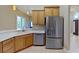 Modern kitchen featuring stainless steel appliances, updated cabinets, and a convenient breakfast bar at 1409 Berkley Ct, Winter Haven, FL 33880