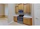 Kitchen featuring oak cabinets, stainless steel appliances, and white countertops at 1409 Berkley Ct, Winter Haven, FL 33880