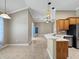 Bright kitchen featuring tile floors, modern stainless appliances, breakfast bar and hanging pendant lights at 1409 Berkley Ct, Winter Haven, FL 33880