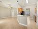 Open-concept living room with tile flooring, kitchen bar, and natural light at 1409 Berkley Ct, Winter Haven, FL 33880