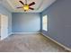 Spacious bedroom with tray ceiling, neutral carpet, and a large window offering ample natural light at 1409 Berkley Ct, Winter Haven, FL 33880