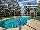 A unique lagoon shaped pool, complete with a built-in hot tub, offers a luxurious outdoor experience at 1409 Berkley Ct, Winter Haven, FL 33880