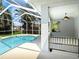 Screened-in pool area with clear blue water, offering a private outdoor oasis at 1409 Berkley Ct, Winter Haven, FL 33880