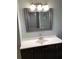Bathroom vanity with modern fixtures and framed mirror at 1550 11Th Ne St # A2, Winter Haven, FL 33881