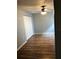 Bedroom features laminate flooring, fresh grey paint, and a closet with double doors at 1550 11Th Ne St # A2, Winter Haven, FL 33881
