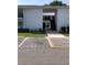 Exterior view of building featuring private resident parking, stairs to units, and mature landscaping at 1550 11Th Ne St # A2, Winter Haven, FL 33881