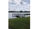 A private wooden dock extends onto the lake, offering a serene waterfront view at 1550 11Th Ne St # A2, Winter Haven, FL 33881